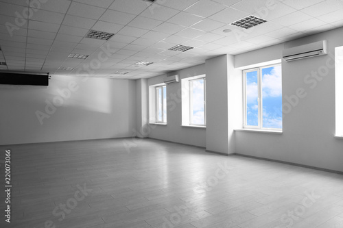 Empty spacious room with big windows