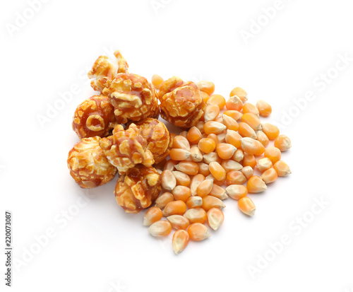 Delicious popcorn and kernels on white background
