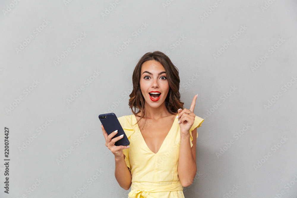 Fototapeta premium Portrait of an excited young girl in dress
