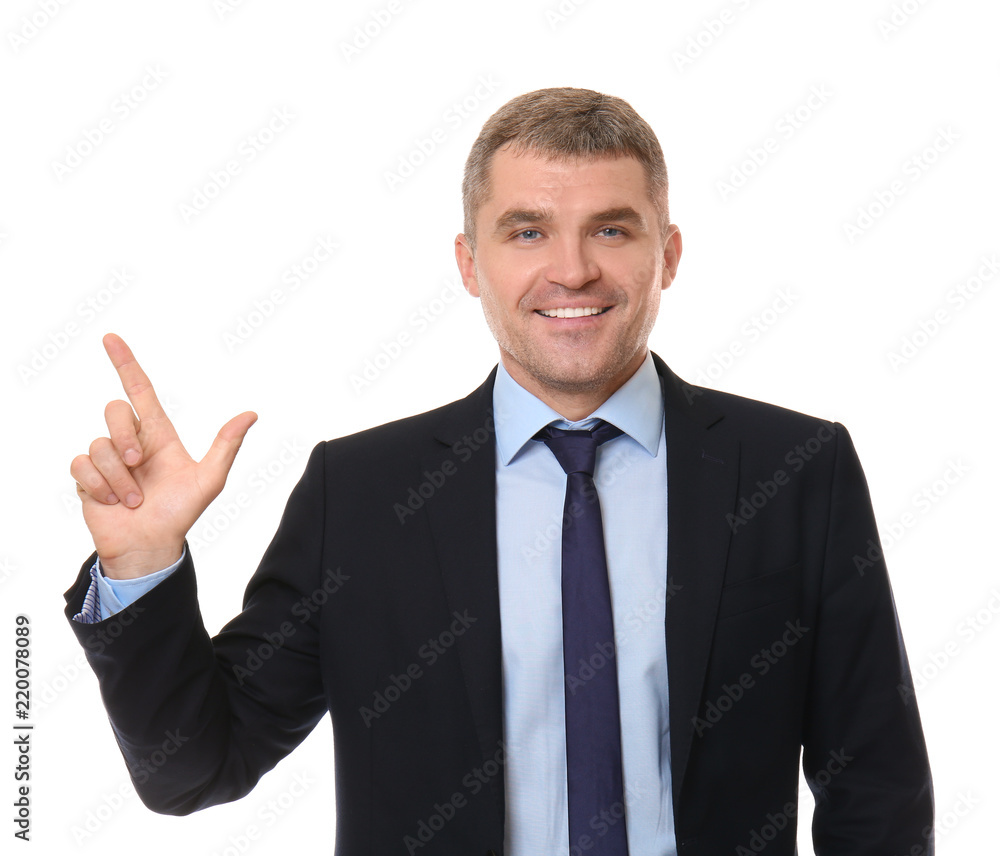 Handsome confident businessman pointing at something on white background Handsome confident businessman pointing at something on white background