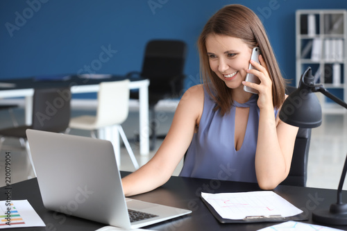 Young businesswoman talking...