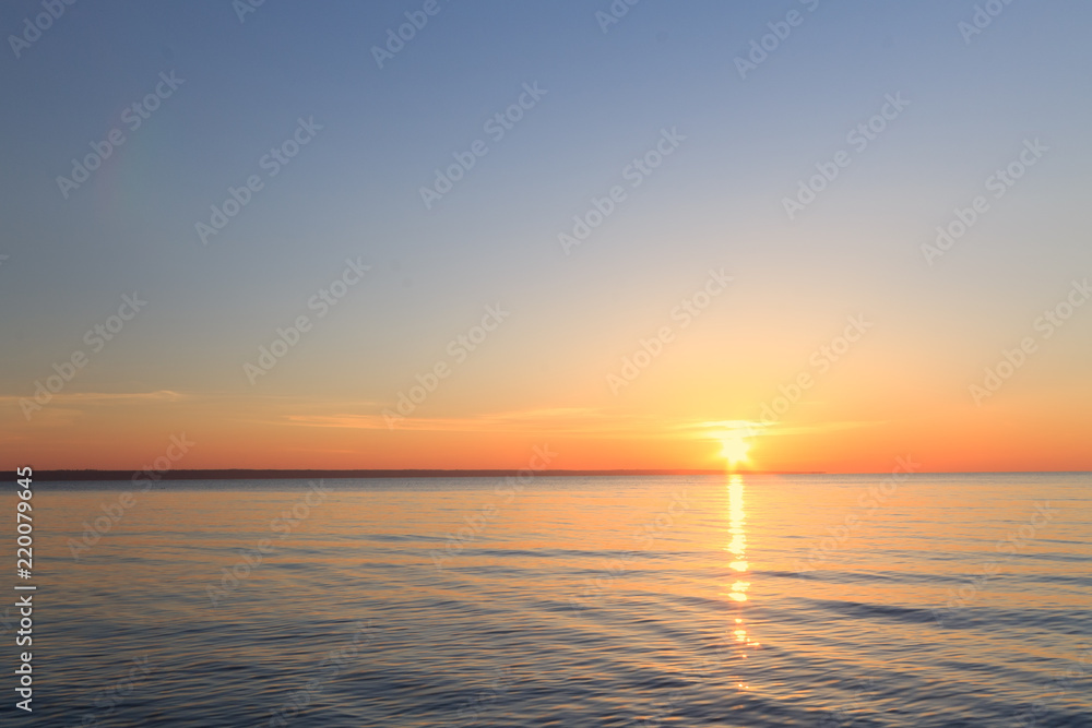 Fototapeta premium sunrise on the water / Early summer morning bright sky Beach