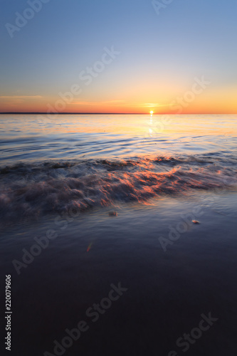 sunrise on the water / Early summer morning bright sky Beach