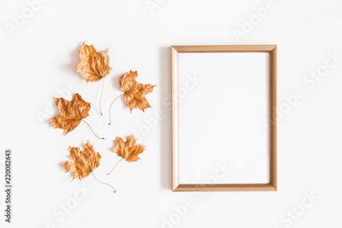 Autumn composition. Golden leaves, photo frame on white background. Autumn, fall concept. Flat lay, top view, copy space