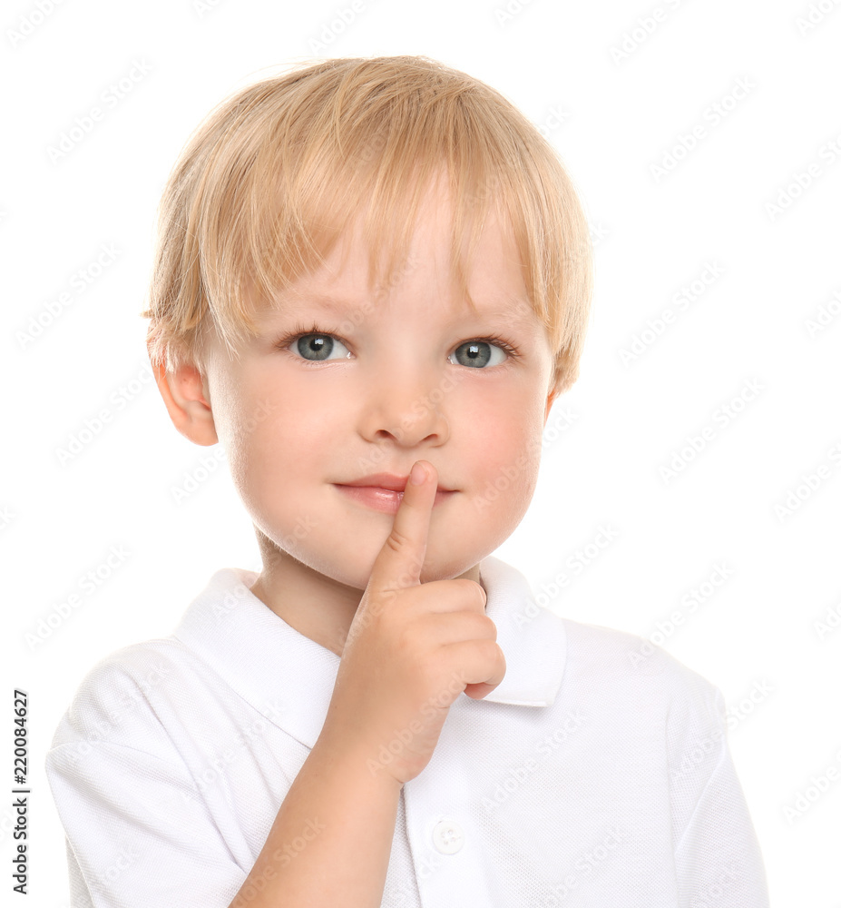 Cute little boy showing silence gesture on white background Cute little boy showing silence gesture on white background