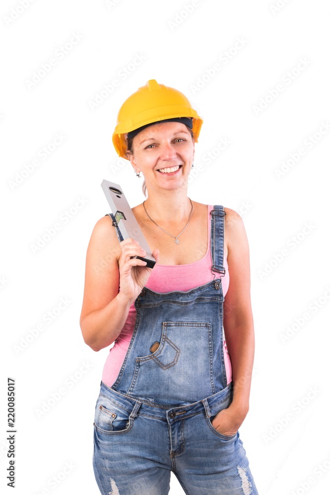 Young Woman as a construction worker with a helmet and a spirit level - Craftsman woman - isolated on white Young Woman as a construction worker with a helmet and a spirit level - Craftsman woman - isolated on white