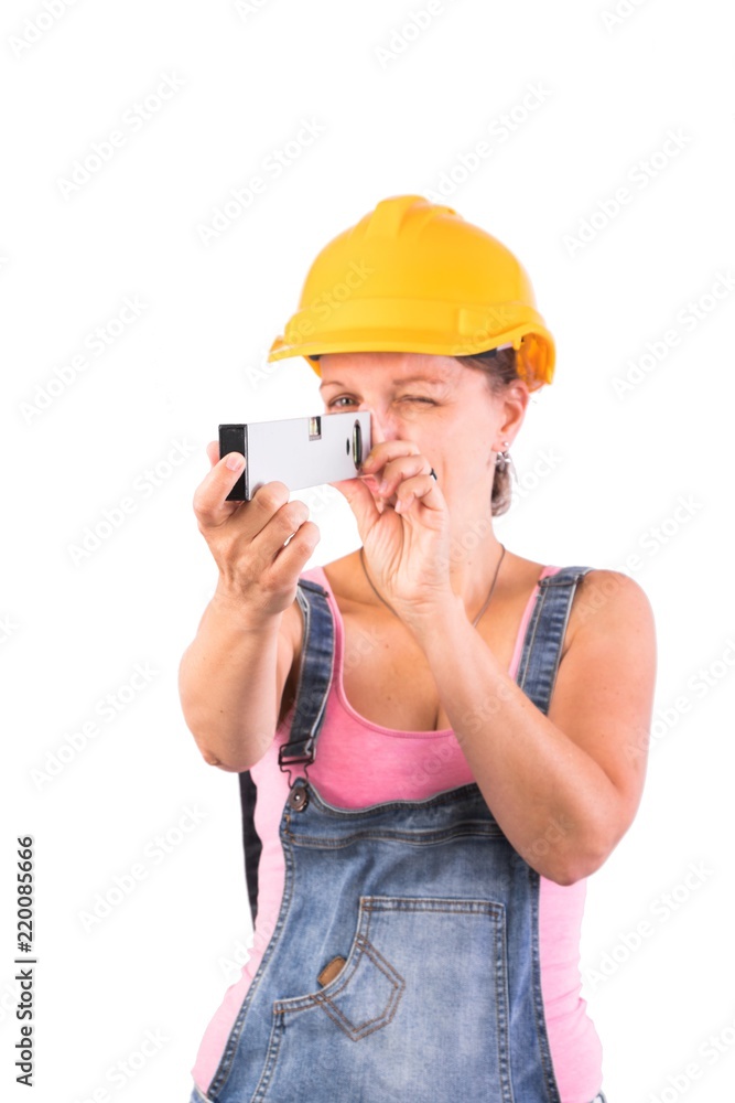 Young Woman as a construction worker with a helmet and a spirit level - Craftsman woman - isolated on white Young Woman as a construction worker with a helmet and a spirit level - Craftsman woman - isolated on white