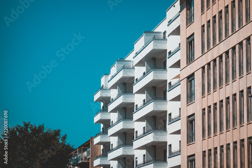 white and orange apartment buildings with darken sky for copy space