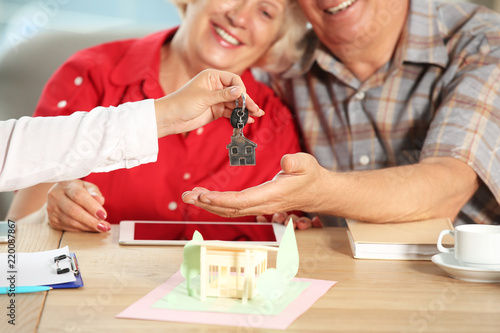 Real estate agent giving ke...