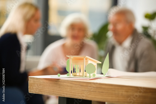 Paper model of house on tab...
