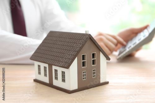 House model on table of rea...