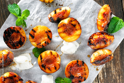 Honey grilled peaches served mint ice cream top view