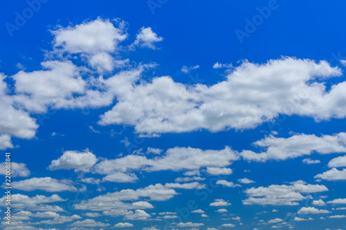 White fluffy clouds in deep blue sky © ihorbondarenko