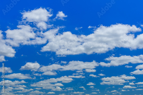 White fluffy clouds in deep blue sky