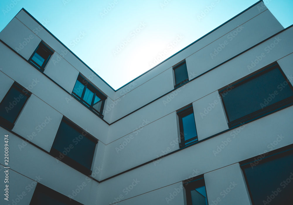 low angle view of white building facade with small copy space in the middle low angle view of white building facade with small copy space in the middle