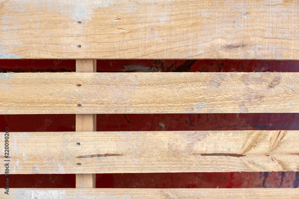 Φωτογραφία A close up of a wooden brick pallet leaning against a metal red skip in South Au