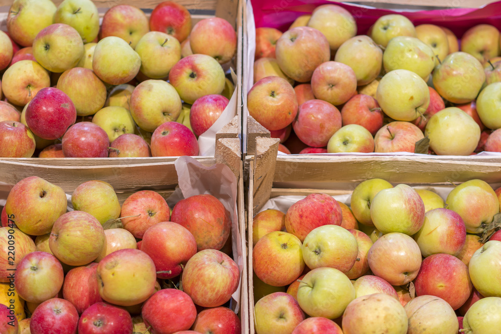 Bunch of red and green apples on boxes in supermarket. Apples in farmer market. Boxes with fresh apples in a grocery store Bunch of red and green apples on boxes in supermarket. Apples in farmer market. Boxes with fresh apples in a grocery store
