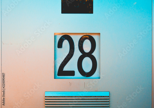 number 28 door sign on steel background photo