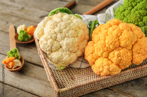 Bilde på lerret Tray with different cauliflower cabbage on wooden table