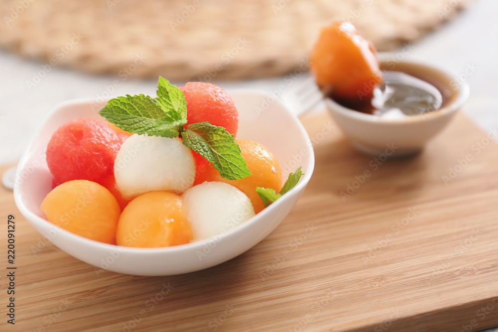 Plate with tasty melon dessert on wooden board Plate with tasty melon dessert on wooden board