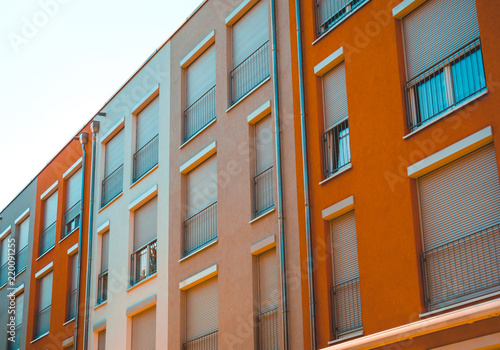 low angle view of modern townhouses with warm colored facades © Robert Herhold