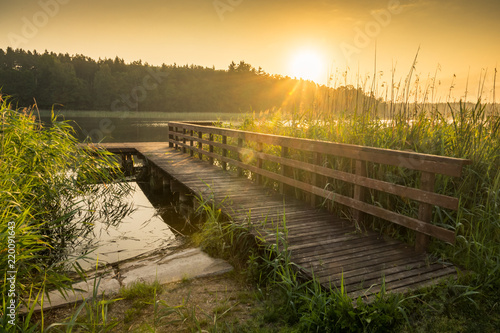 Fototapeta Naklejka Na Ścianę i Meble -  Footbridge on the Wydminskie lake in Wydminy, Masuria, Poland