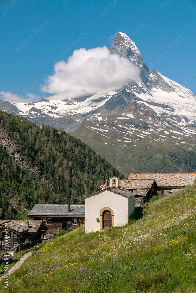 Obraz premium Zermatt village with little chapel and Matterhorn (Monte Cervino, Mont Cervin) in background. Beautiful outdoor scene in Swiss Alps, Valais canton, Switzerland, Europe.