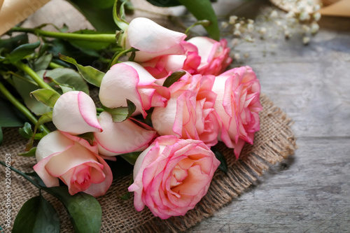 Beautiful roses on wooden table