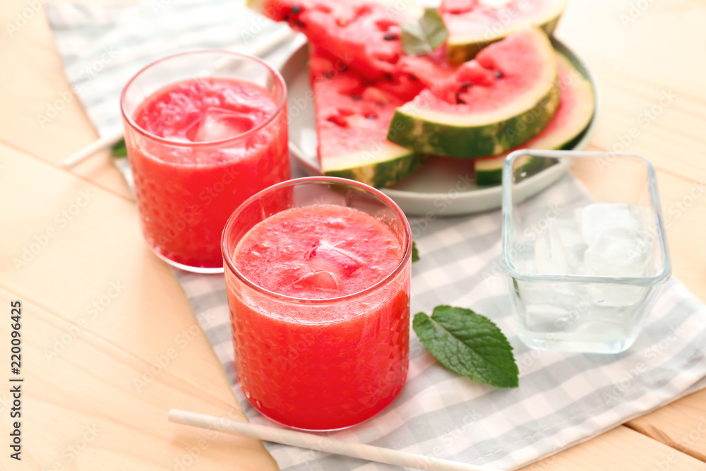 Glasses with fresh watermelon smoothie on wooden table Glasses with fresh watermelon smoothie on wooden table