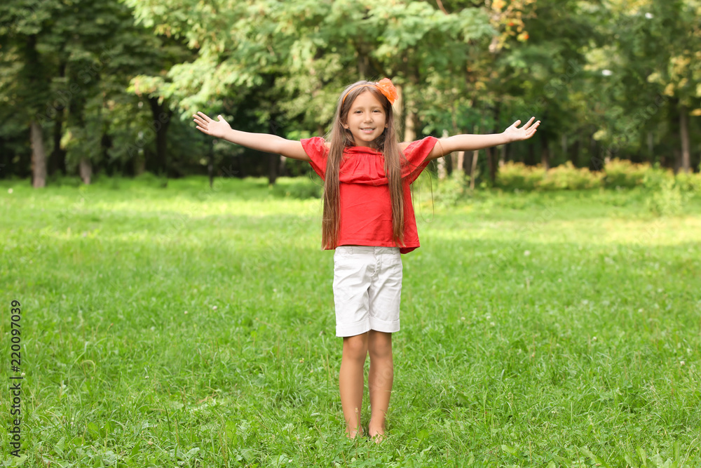 Cute little girl in park on summer day