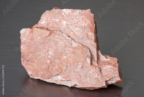 Specimen of mineral feldspar on gray background photo