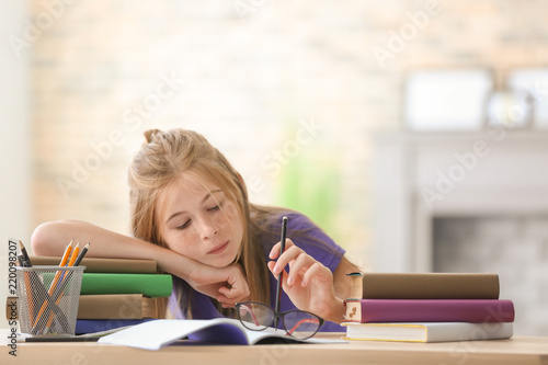 Bored schoolgirl doing home...