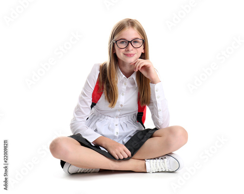 Canvas Print Cute schoolgirl with backpack on white background