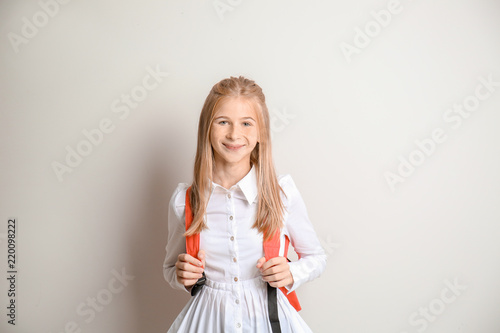 Cute schoolgirl with backpa...