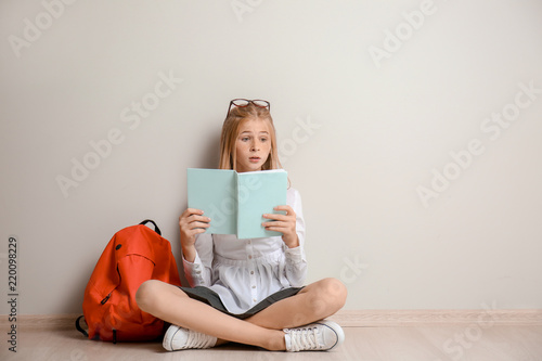 Cute schoolgirl with backpa...