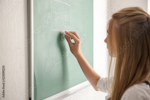 Cute schoolgirl writing wit...
