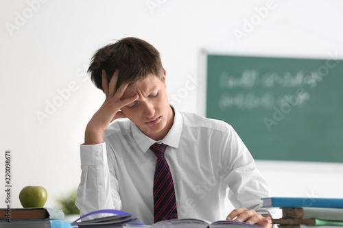 Tired teenage boy at lesson...