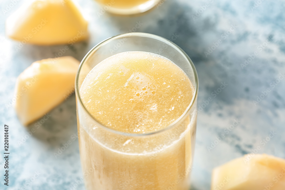 Glass with delicious melon smoothie on light background, closeup Glass with delicious melon smoothie on light background, closeup