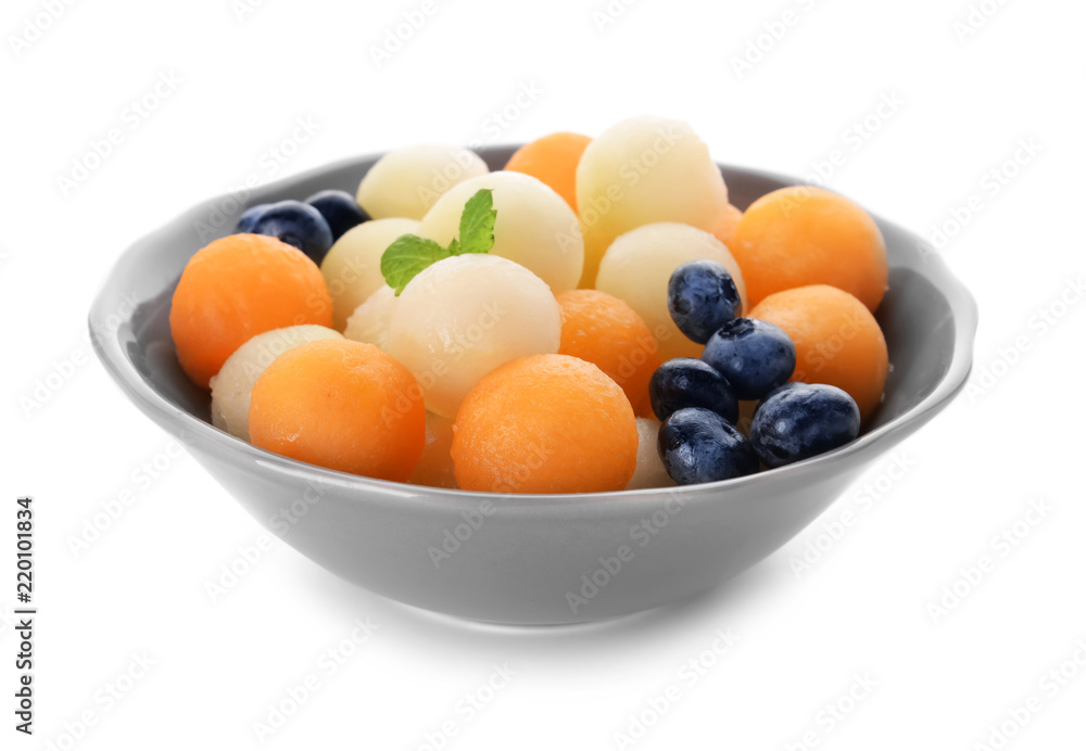 Plate with tasty melon balls and berries on white background Plate with tasty melon balls and berries on white background