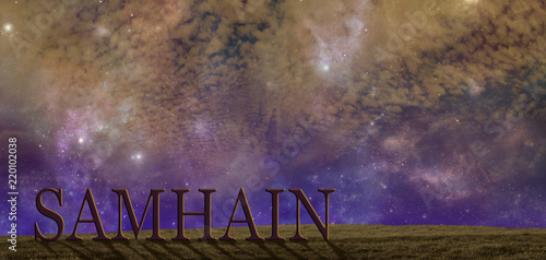 Celebrate Samhain summers end background - warm coloured starry cloudy autumnal night sky background with a simple grassy hilltop and the word SAMHAIN  and copy space above photo