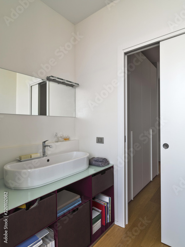 interiors shots of a modern bathroom in the foreground the counter top washbaslin