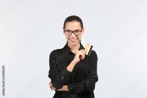 Happy young woman with cred...
