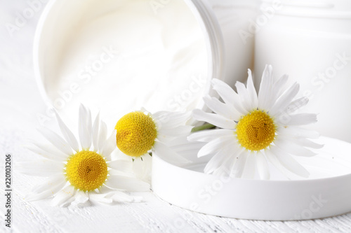 Jar of face cream or body cream with camomile flower