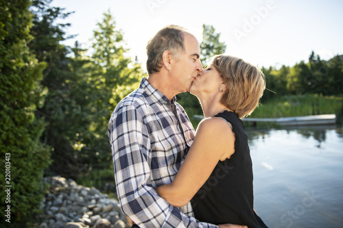 Couple outdoors by lake having good time