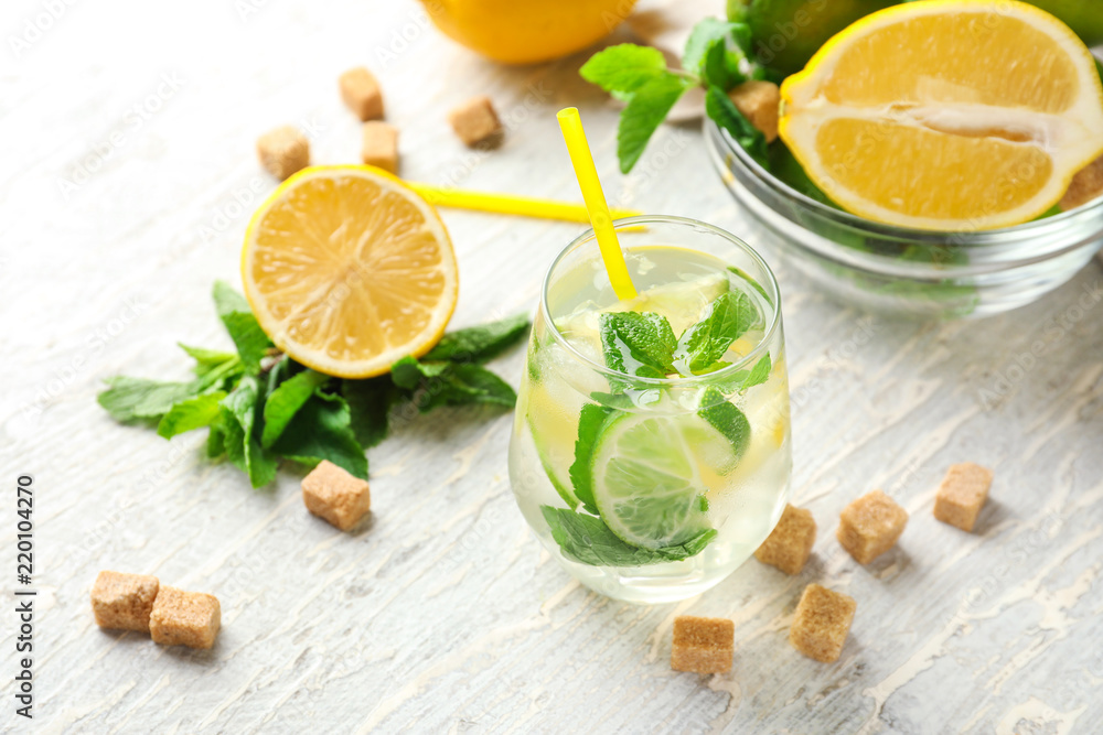 Glass of fresh mojito on light wooden table Glass of fresh mojito on light wooden table