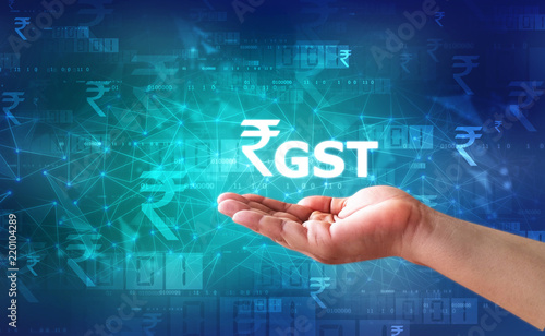 Businessman Holding GST India Word, GST Tax India Concept with business graph