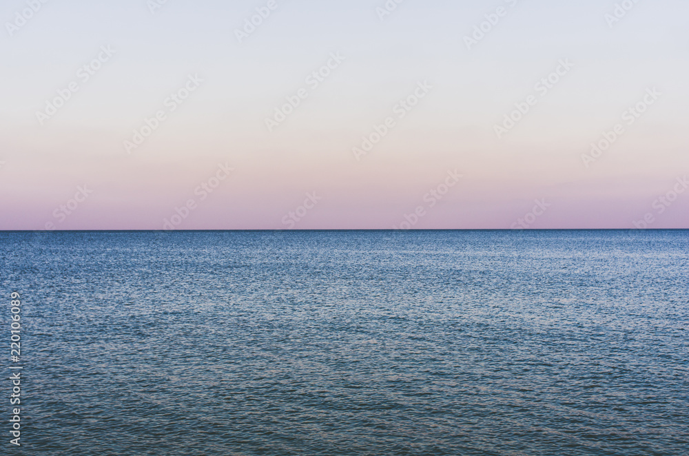 Fototapeta premium Evening seascape with endless horizon and calm water