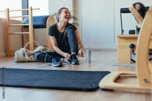 Woman at a pilates gym getting ready to leave photo