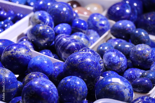 Cobalt blue lapis lazuli balls with white veins. Selected focus. Minerals exhibition. photo
