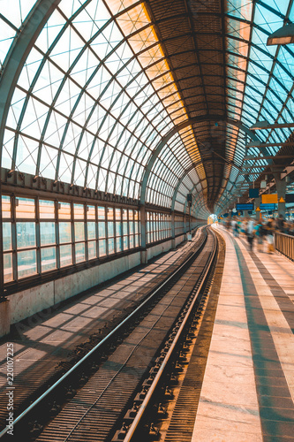 modern and curved train station with blurred traveler